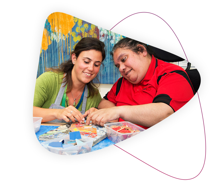 Two friends smiling and enjoying art and crafts together.