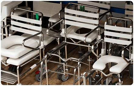 white and chrome toilet chairs are grouped together after sterilisation.