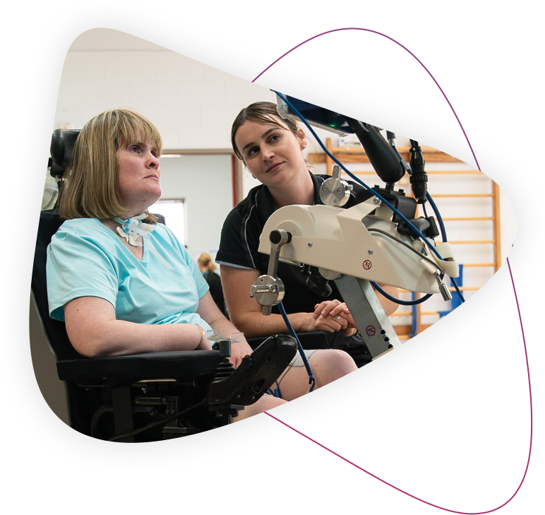 Therapist and customer using a piece of therapy equipment