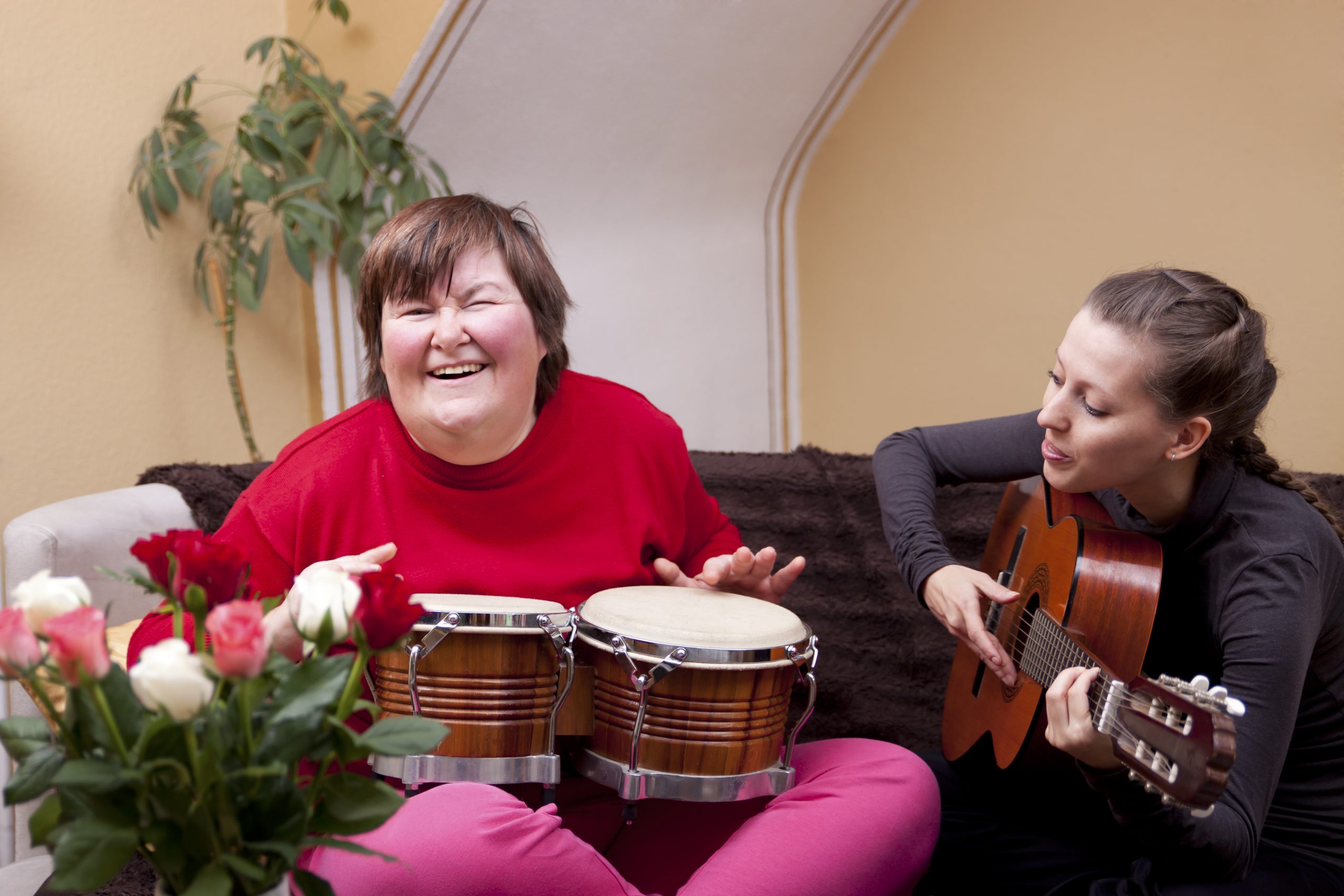 Person with disability playing music and smiling