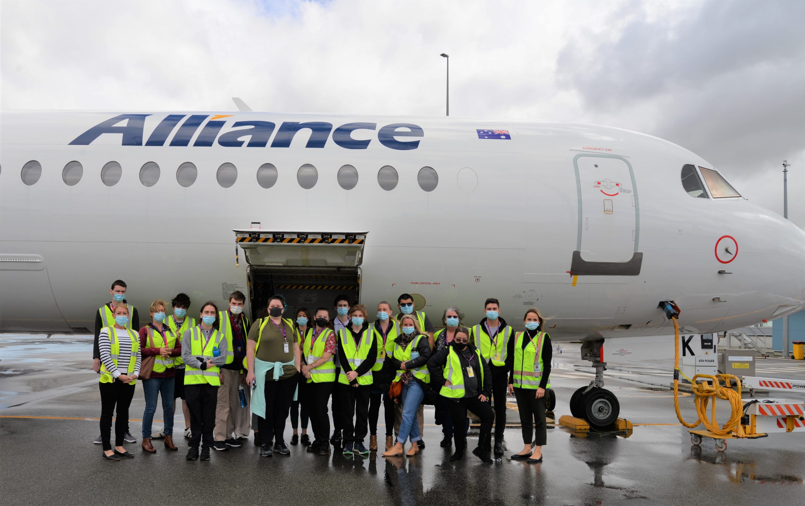 Rocky Bay customers standing in front on an Alliance Airlines plane at Perth Airport