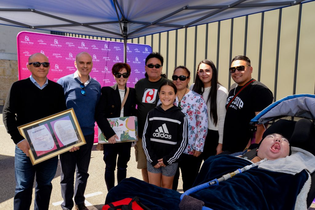 The Carcione and Ngamoki-Stevens families after the presentation of a modified van to Tamati