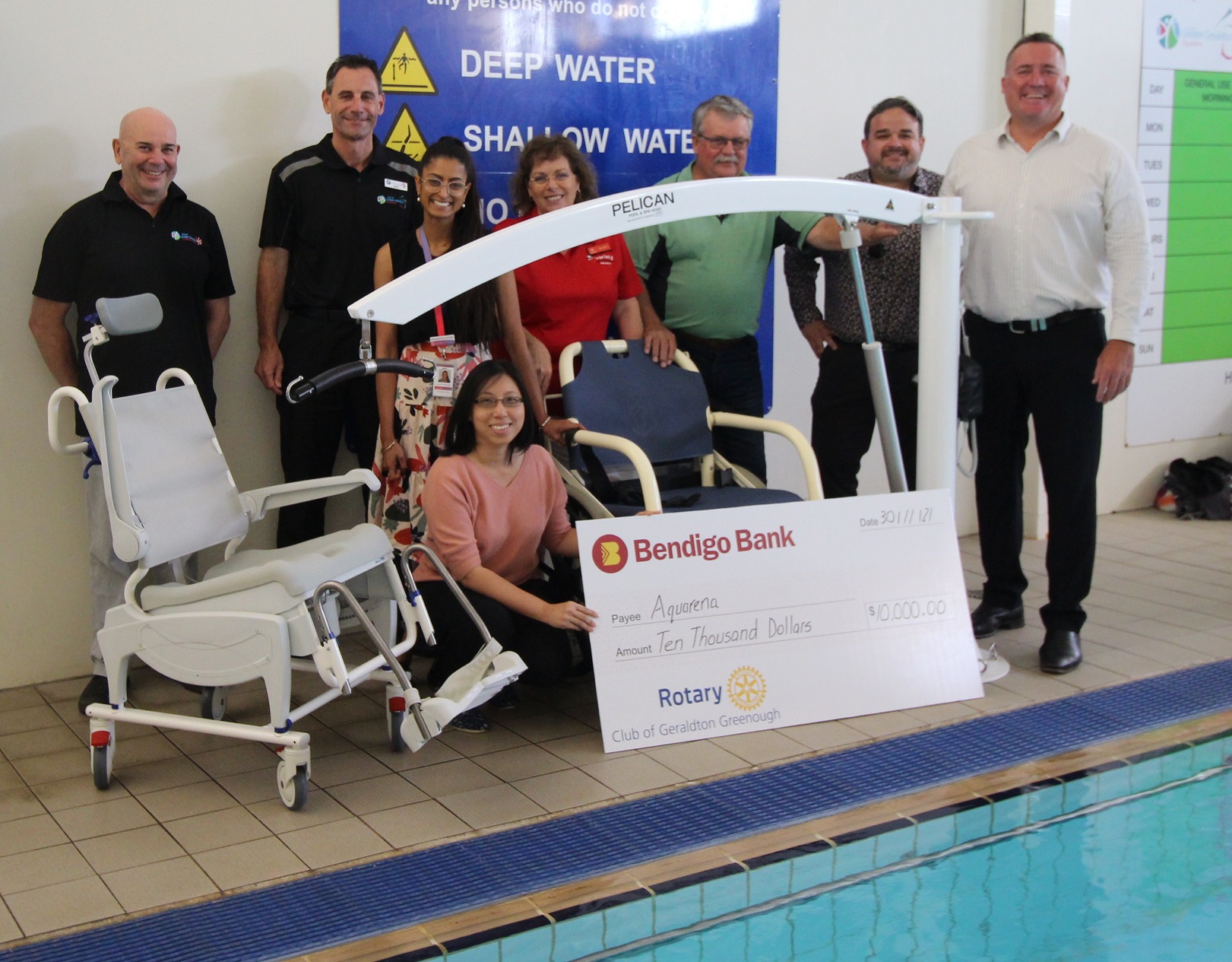 Representatives from the organisations who made the accessibility equipment possible for Aquarena are posing for a group photo with the equipment