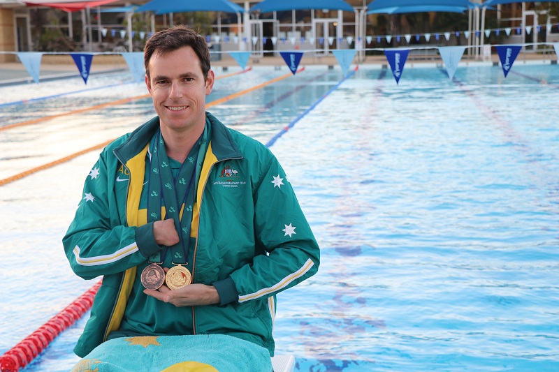 Paul Barnett, at Geraldton pool, shows off his gold and bronze Paralympic medals