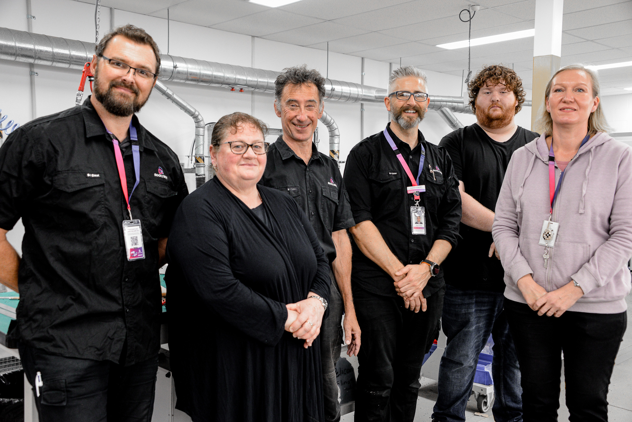 The Rocky Bay Equipment team posing for a group photo in the warehouse.