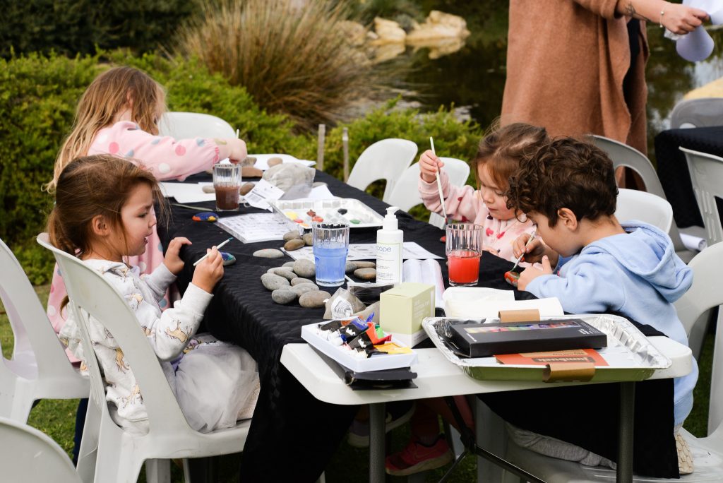 Four children are enjoying the art and craft space at the NAIDOC celebrations