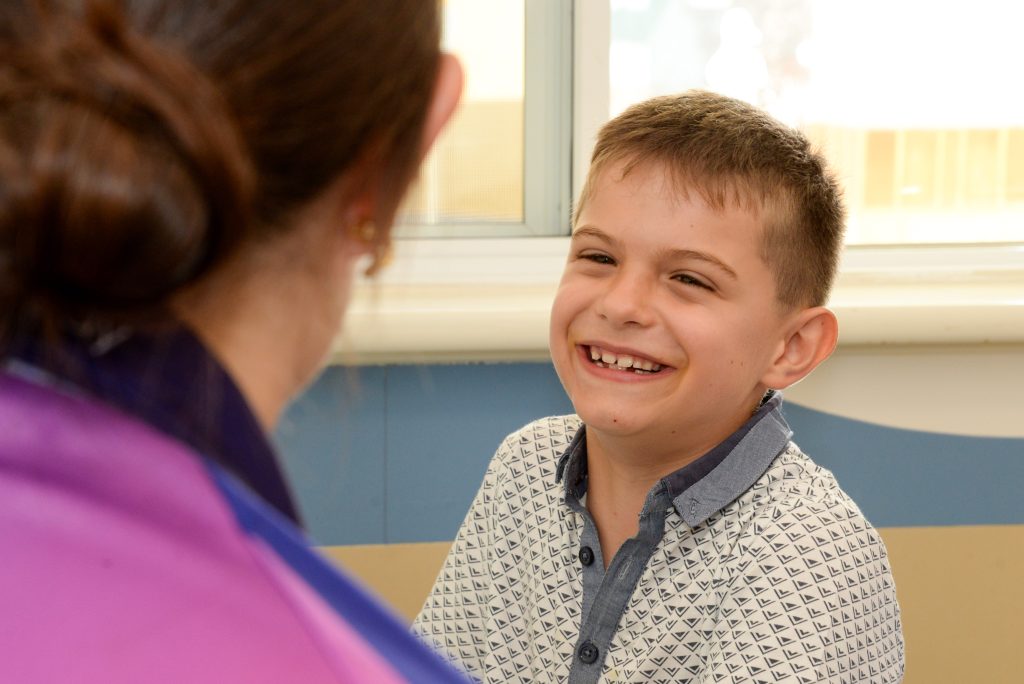 A young boy talks to a Rocky Bay therapist