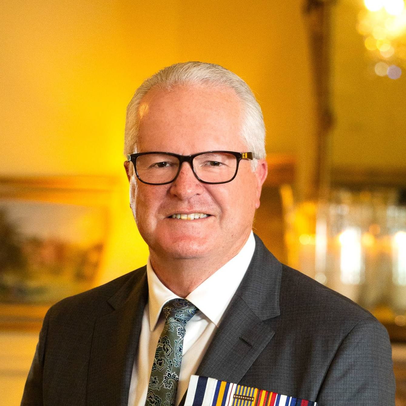 A photo of his Excellency the Honourable Chris Dawson. Chris is smiling and looking at the camera.