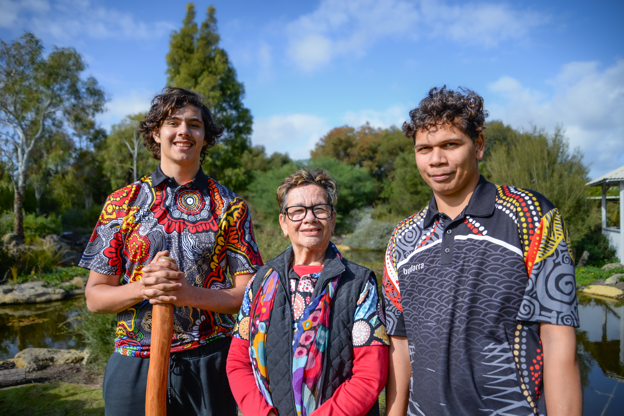 Robyn Collard (centre) with grandsons Tryse and Albert on either side. They are standing in the Rocky Bay garden.