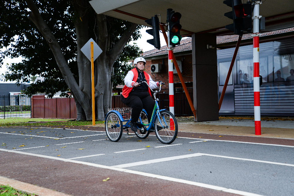 Photo of Rocky Bay customer riding a bike on a quiet street. He is wearing a helmet.
