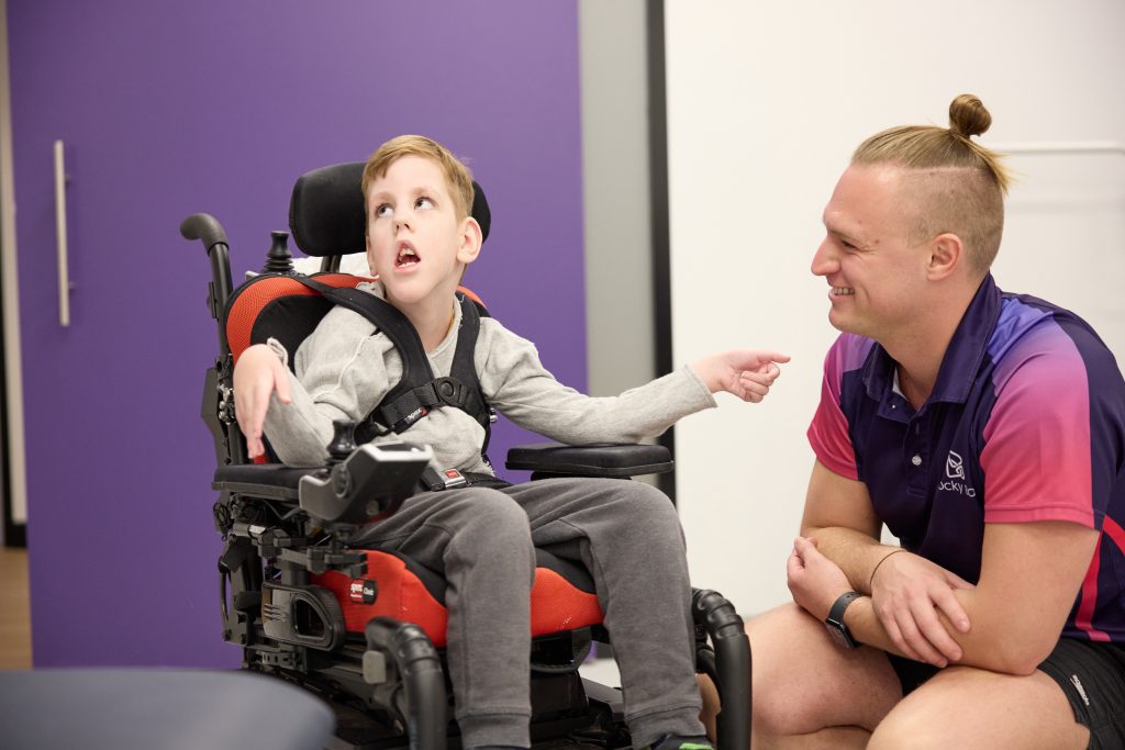 Young Rocky Bay customer in a wheelchair, accessing services with Rocky Bay therapist