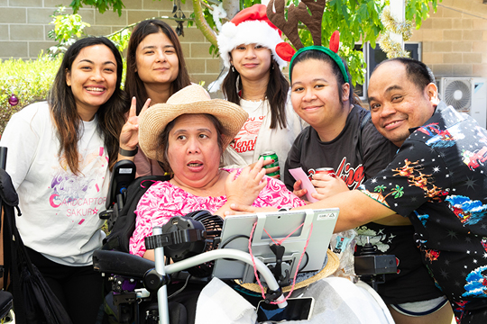 Photo of Rocky Bay customers having fun at Family Fun Day. They are smiling at the camera.