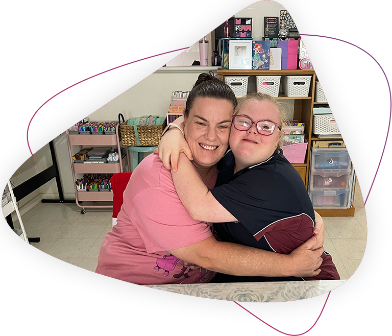 Pictured right is Rocky Bay customer Lileigh and pictured left is Mum Bec. They are hugging each other and smiling at the camera.