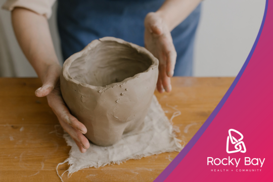 A persons hands working with clay