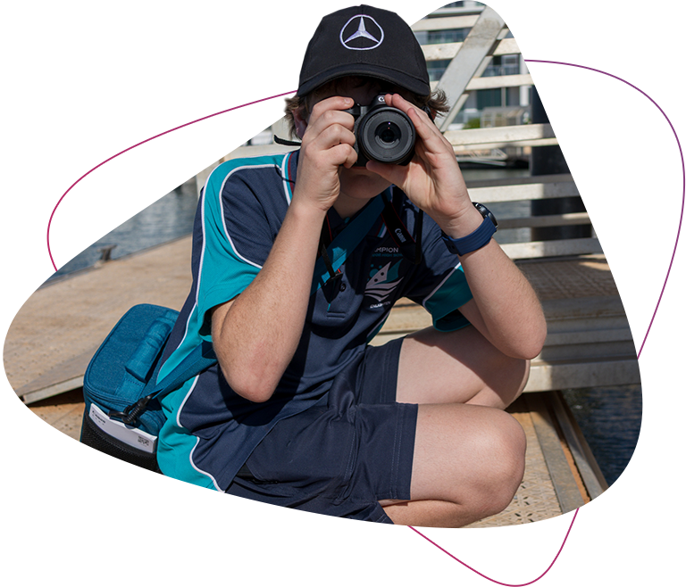 A picture of Rocky Bay customer Blake as he is holding his camera up to his face like he is taking a photo of the photographer.