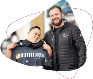 Rocky Bay customer Fenton proudly holds up his rugby jersey.