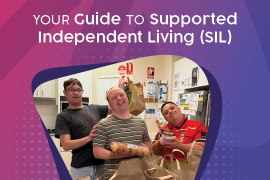 SIL customers at home holding up their shopping bags and smiling to the camera.
