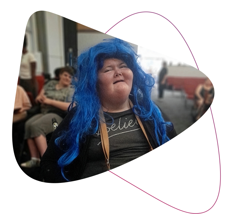 Jemma dressed up with a blue wig on, smiling.